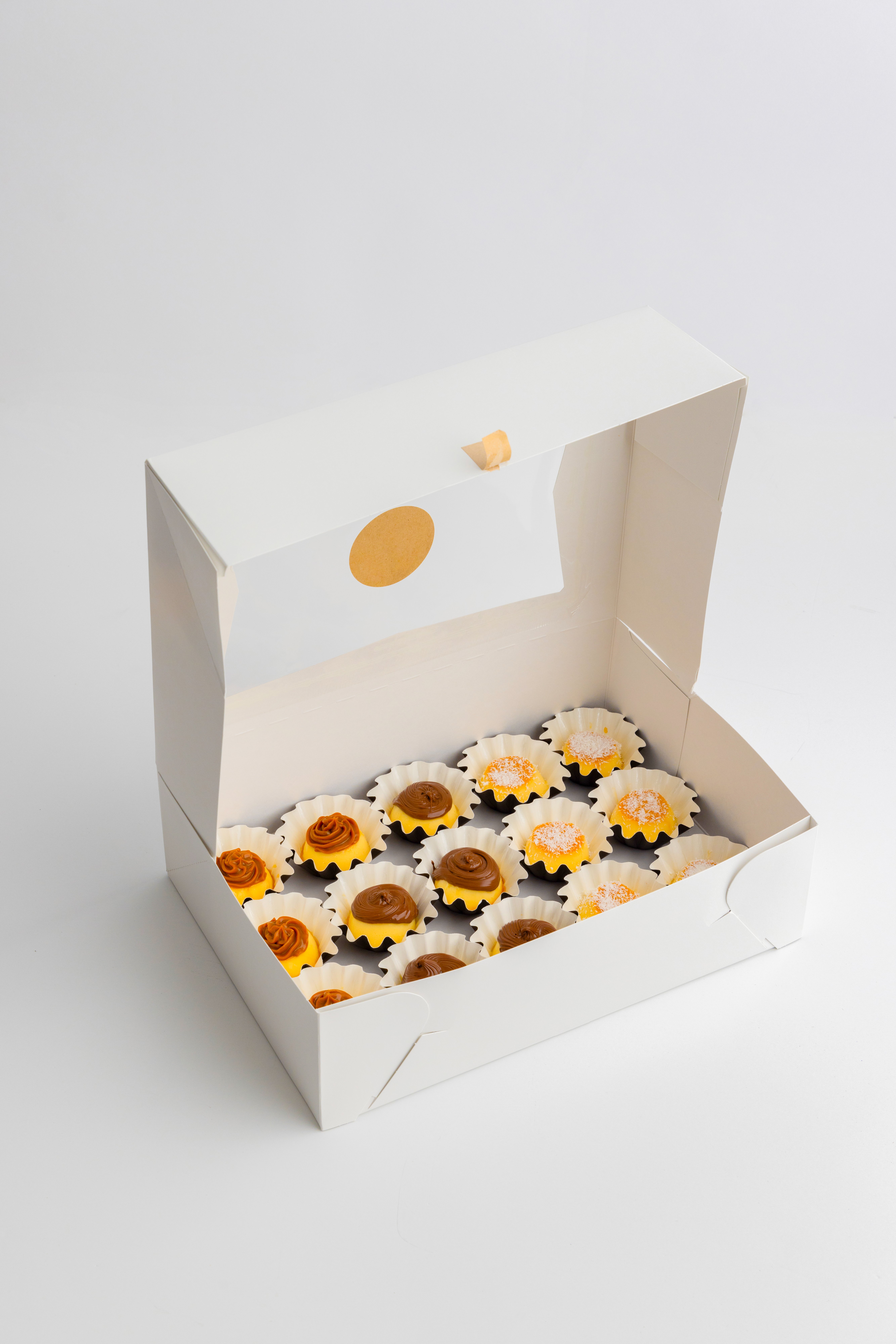 A box of golden mini flans topped with caramel
